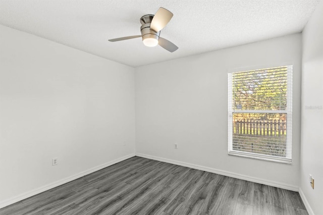 spare room featuring a textured ceiling, ceiling fan, and dark hardwood / wood-style flooring