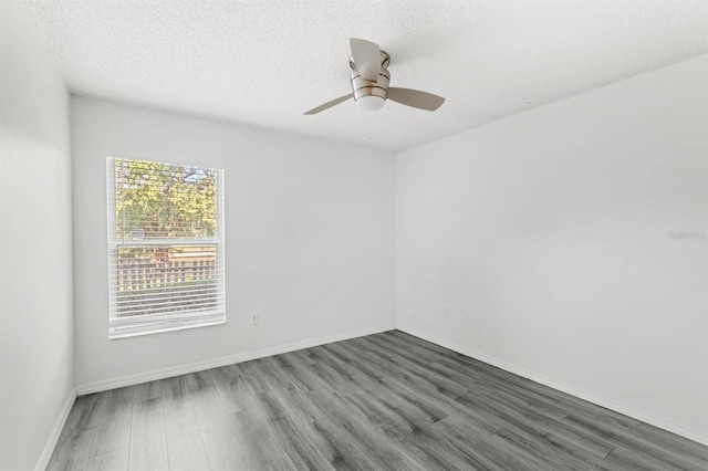 spare room featuring ceiling fan, a textured ceiling, and dark hardwood / wood-style flooring