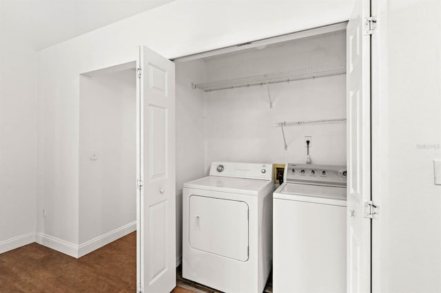 laundry area with washer and dryer and dark hardwood / wood-style floors