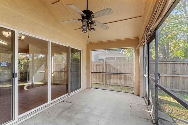 unfurnished sunroom featuring lofted ceiling and ceiling fan