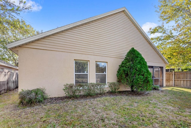 view of side of home featuring a yard