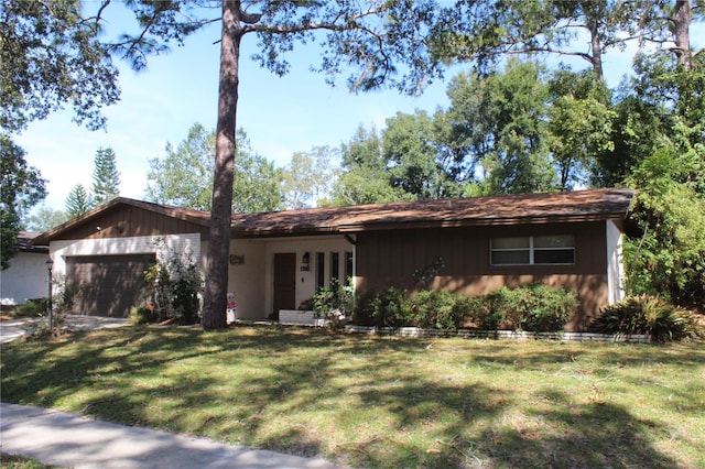 ranch-style home with a front yard and a garage