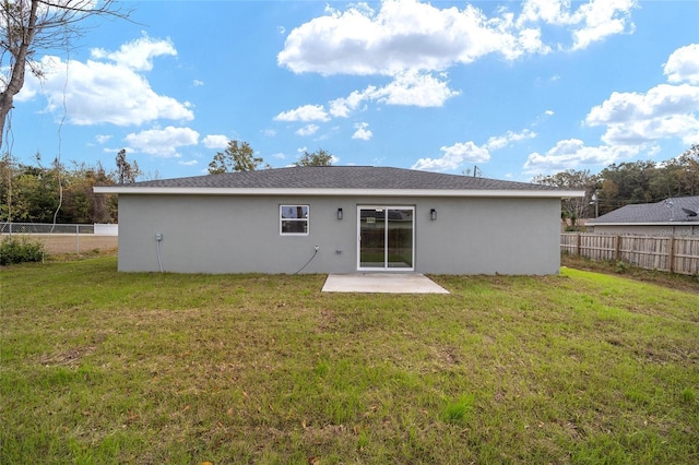 back of house featuring a yard and a patio area