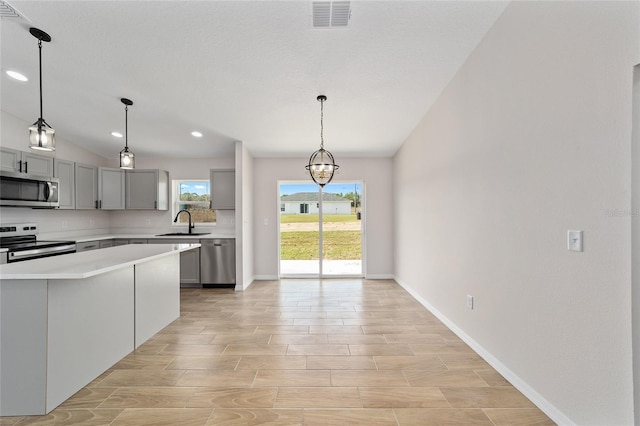 kitchen featuring stainless steel appliances, a sink, visible vents, light countertops, and gray cabinets