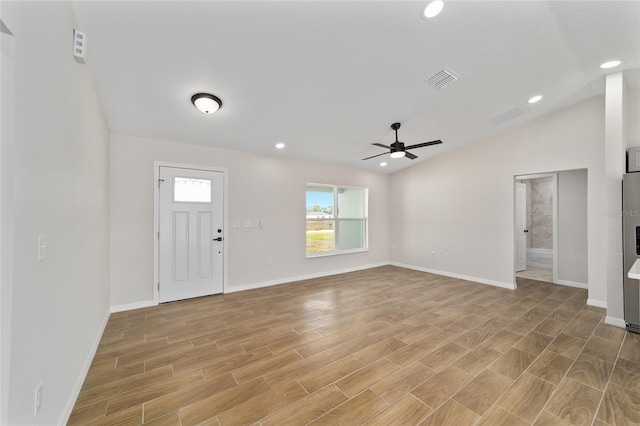 foyer entrance featuring lofted ceiling, light wood-style flooring, visible vents, and recessed lighting