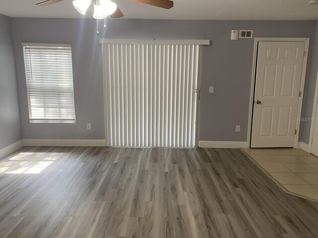 empty room featuring hardwood / wood-style flooring and ceiling fan