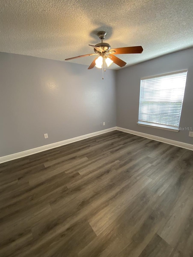 spare room featuring a textured ceiling, ceiling fan, and dark hardwood / wood-style flooring