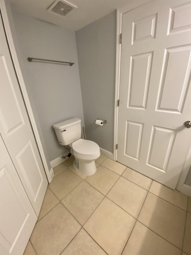 bathroom featuring toilet and tile patterned floors