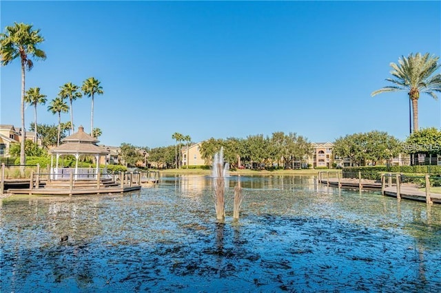 dock area with a gazebo and a water view