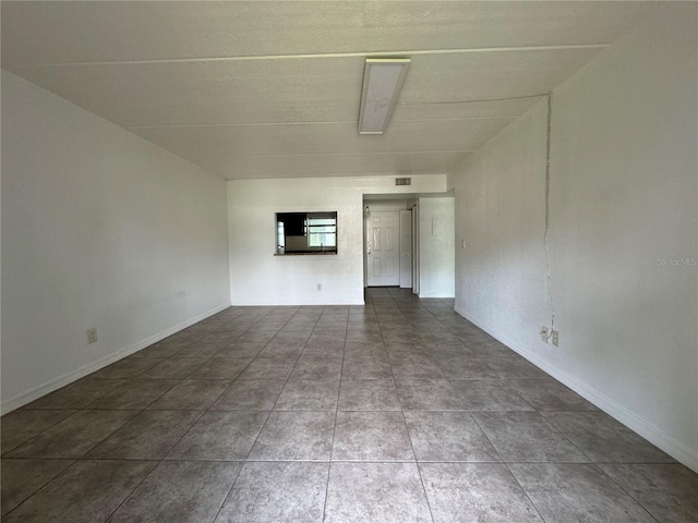 unfurnished room with tile patterned floors