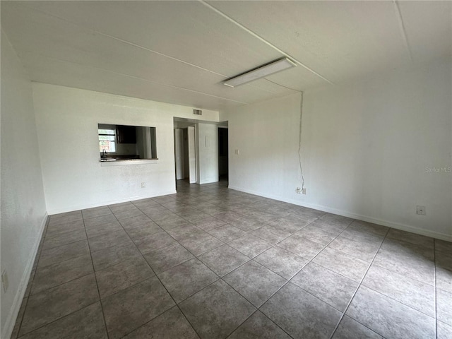 spare room with tile patterned floors