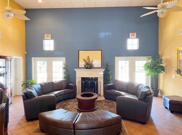 living room featuring light tile patterned flooring, a wealth of natural light, and french doors