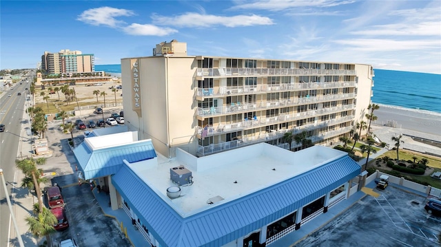 view of property with a view of the beach and a water view