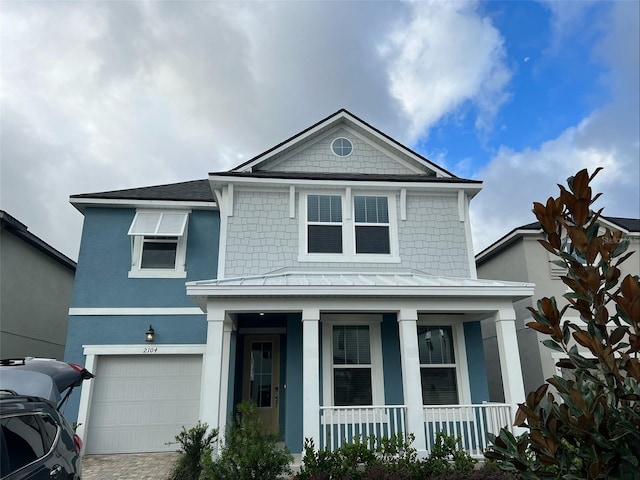 view of front of home featuring a porch and a garage