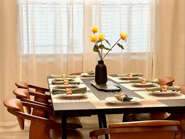 dining area featuring a healthy amount of sunlight and tile patterned flooring