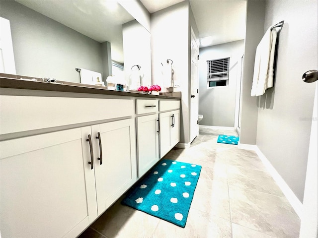 bathroom with vanity, toilet, and tile patterned flooring