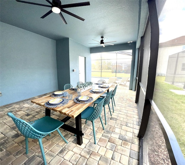 sunroom featuring ceiling fan