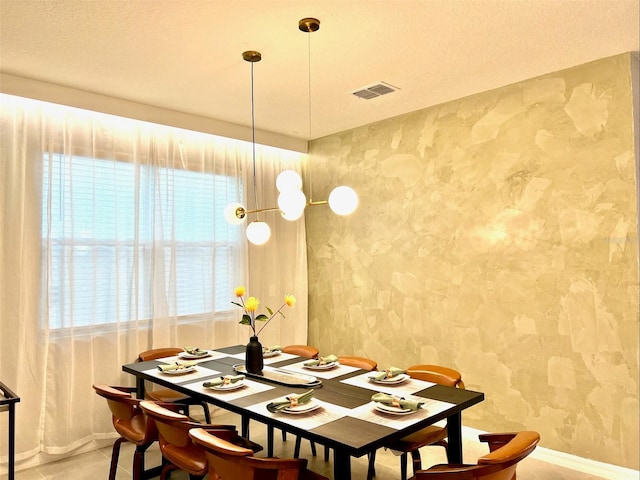 dining space featuring a textured ceiling