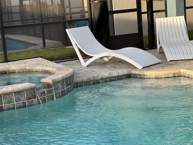 view of pool featuring an in ground hot tub and pool water feature