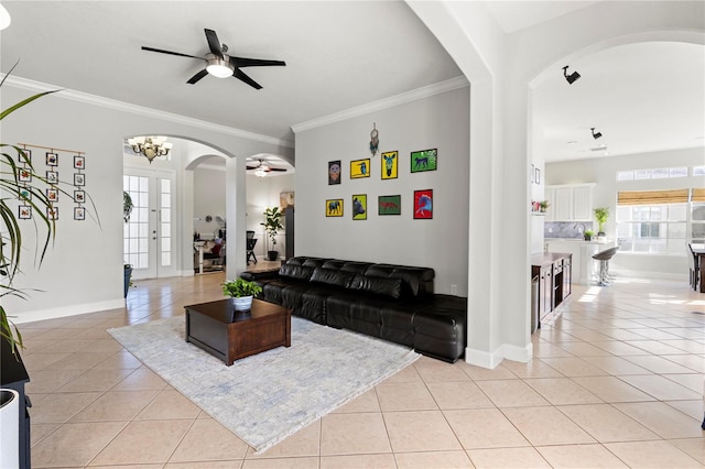 tiled living room featuring ceiling fan and crown molding