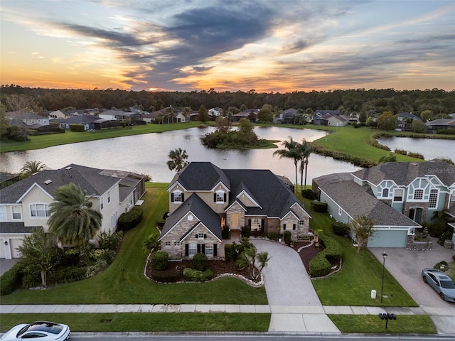 aerial view at dusk with a water view