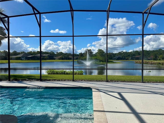 view of pool with a lanai and a water view