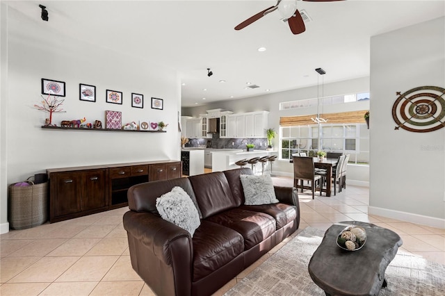 tiled living room with ceiling fan