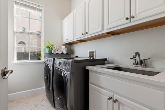 laundry room with sink, cabinets, independent washer and dryer, and light tile patterned floors