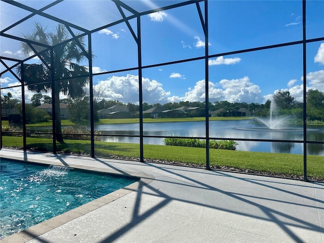 view of swimming pool featuring a water view, a lanai, and a yard