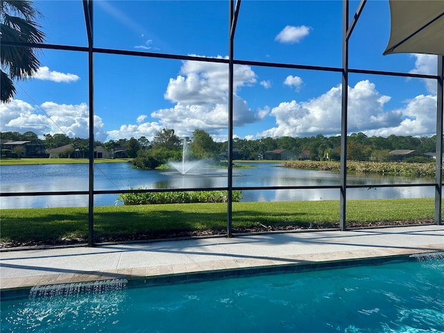 view of swimming pool with a water view and a yard