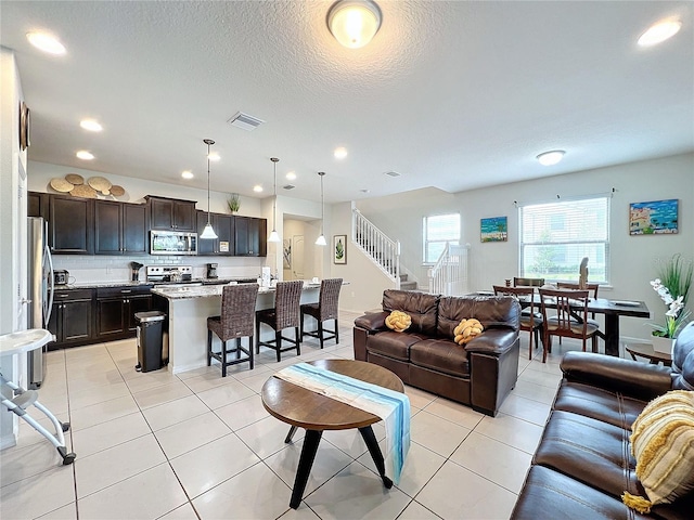 tiled living room with a textured ceiling