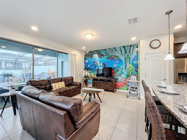 living room with light tile patterned flooring and a textured ceiling