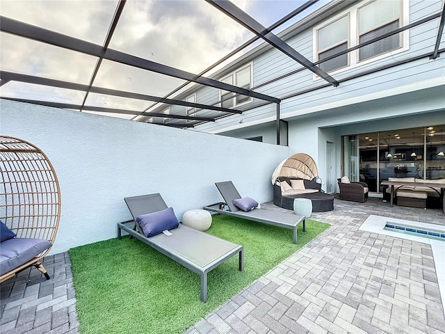 view of patio featuring an outdoor living space and a lanai