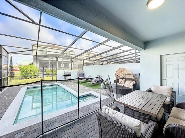 view of swimming pool with a patio, a lanai, and outdoor lounge area