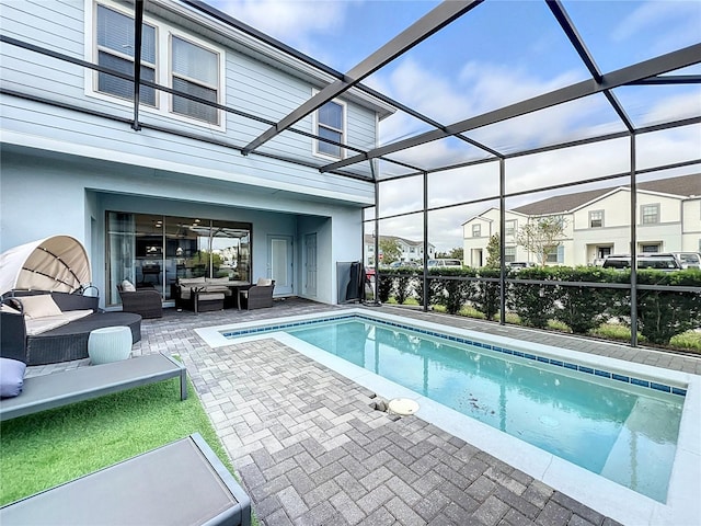 view of pool featuring an outdoor hangout area, a patio area, and a lanai