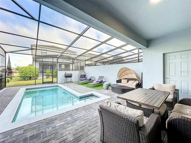 view of swimming pool with a patio area and a lanai