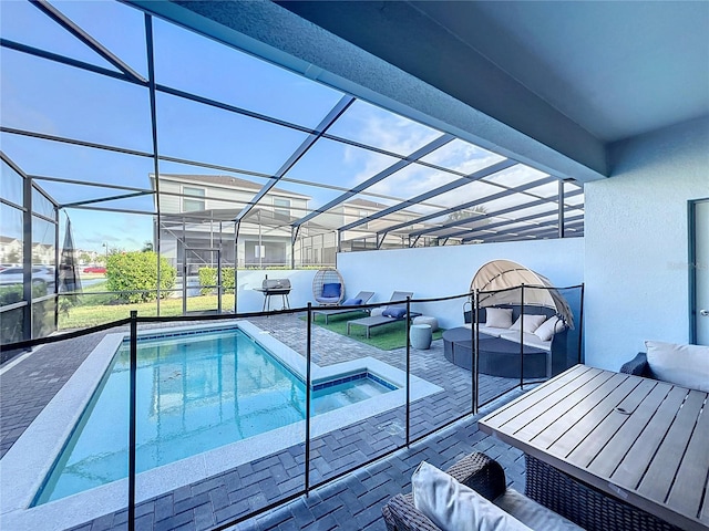 view of pool featuring an outdoor living space, a patio, glass enclosure, and a jacuzzi