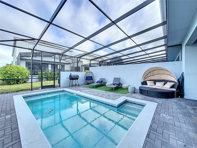 view of pool with a patio, a jacuzzi, and glass enclosure