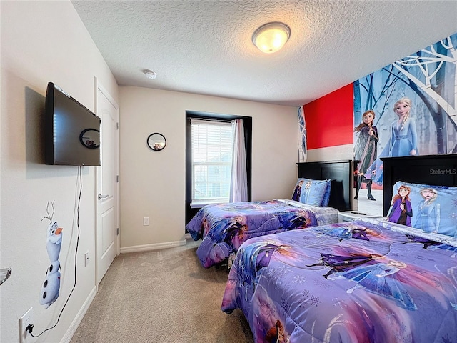 bedroom with light carpet and a textured ceiling