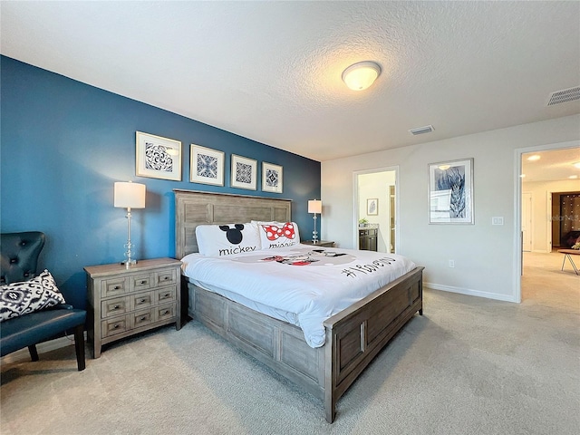 carpeted bedroom featuring a textured ceiling