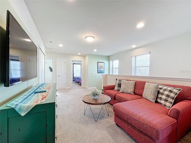 carpeted living room with a textured ceiling