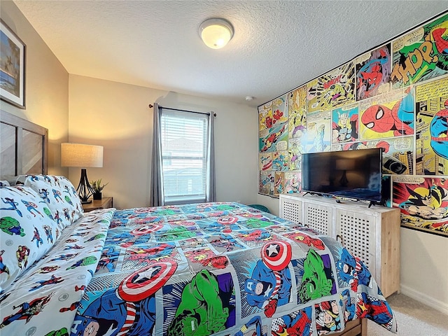 bedroom featuring a textured ceiling and carpet floors