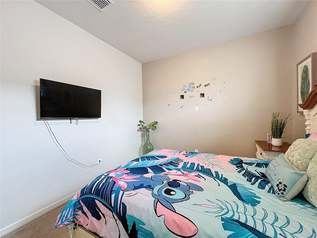 bedroom with carpet and a textured ceiling