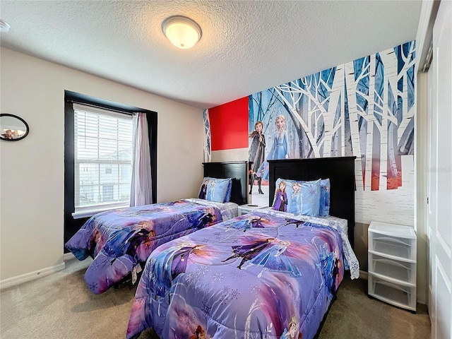 carpeted bedroom featuring a textured ceiling