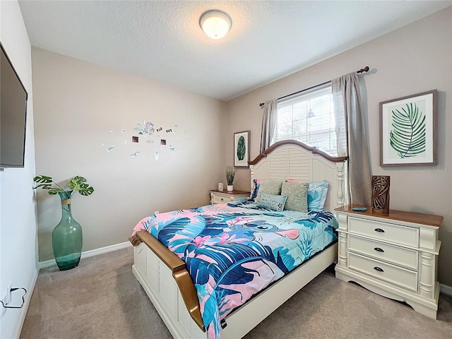 bedroom featuring a textured ceiling and light colored carpet