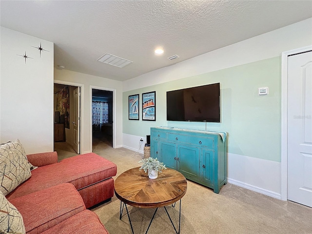 carpeted living room with a textured ceiling