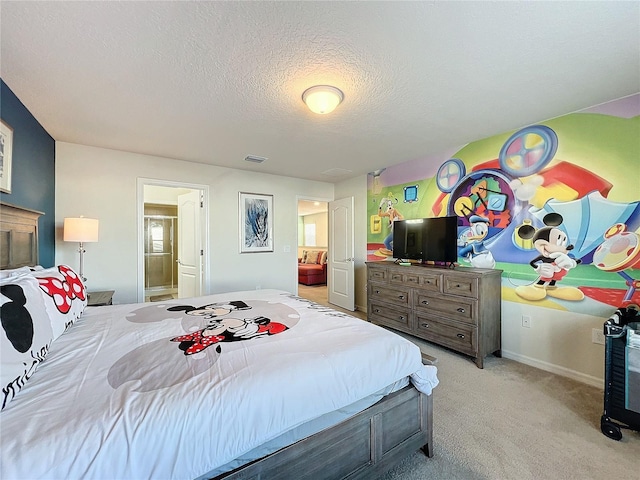 bedroom featuring connected bathroom, a textured ceiling, and light colored carpet