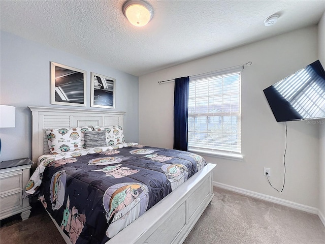 carpeted bedroom featuring a textured ceiling