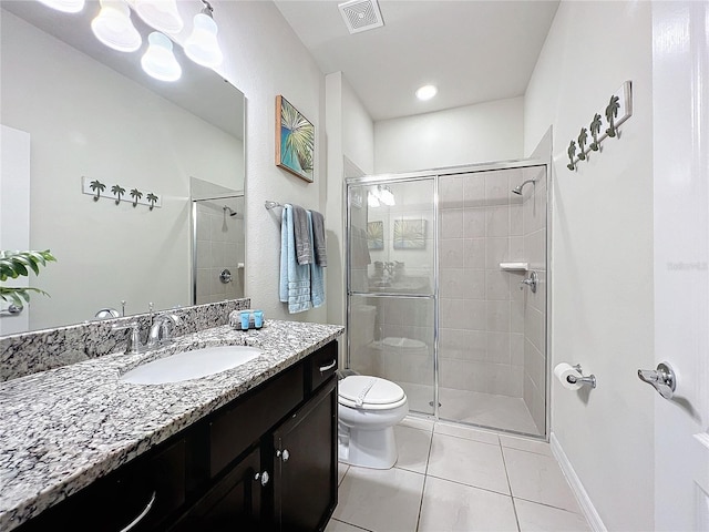 bathroom featuring vanity, tile patterned floors, toilet, and walk in shower