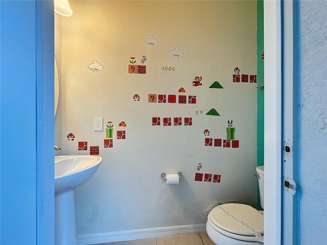 bathroom featuring toilet and tile patterned floors